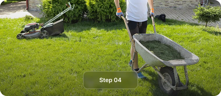 Wheelbarrow of grass clippings next to a mower, step 4 of West End Vancouver lawn mowing