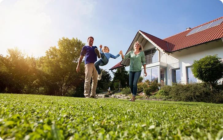 Family walking toward the camera on a freshly mowed lawn, West End Vancouver lawn mowing