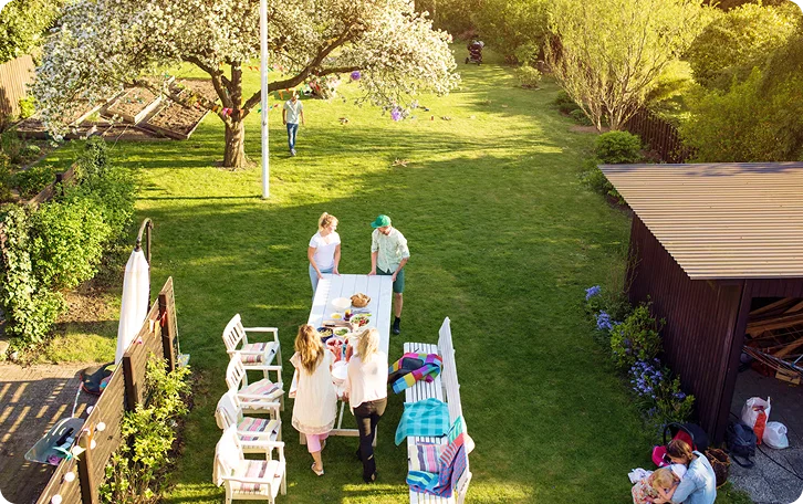 Overhead view of a long mowed backyard lawn with a garden party, West End Vancouver lawn mowing