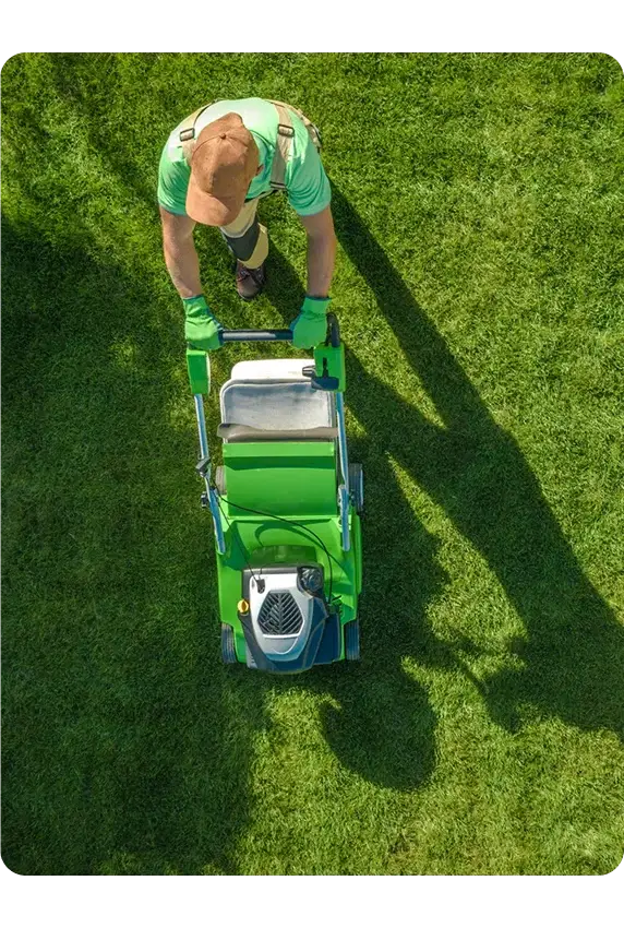 harry's lawn care employee going with maching after completion lawn mowing working Surrey