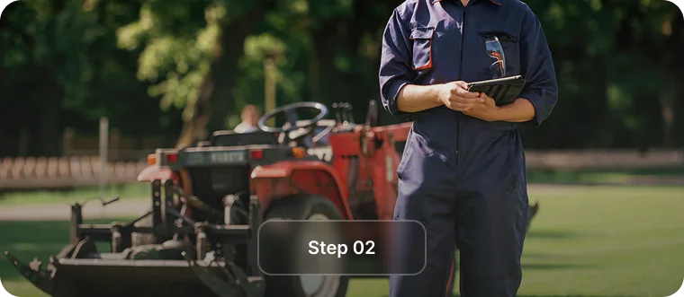 Technician with a clipboard beside a red turf machine, step 2 of property lawn care in Vancouver