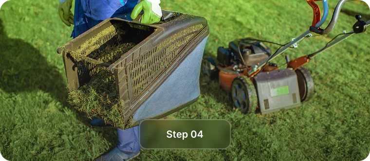 Worker emptying a mower grass catcher full of clippings, step 4 of rental property lawn care in Vancouver