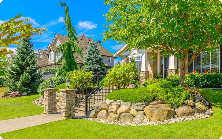 Suburban home with a rock garden, evergreens and edged lawn for property lawn care in Vancouver