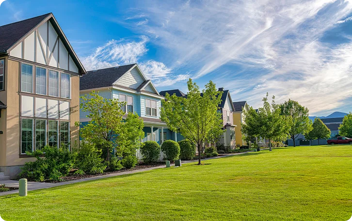 Wide green lawn in front of Tudor-style homes kept neat by property lawn care in Vancouver